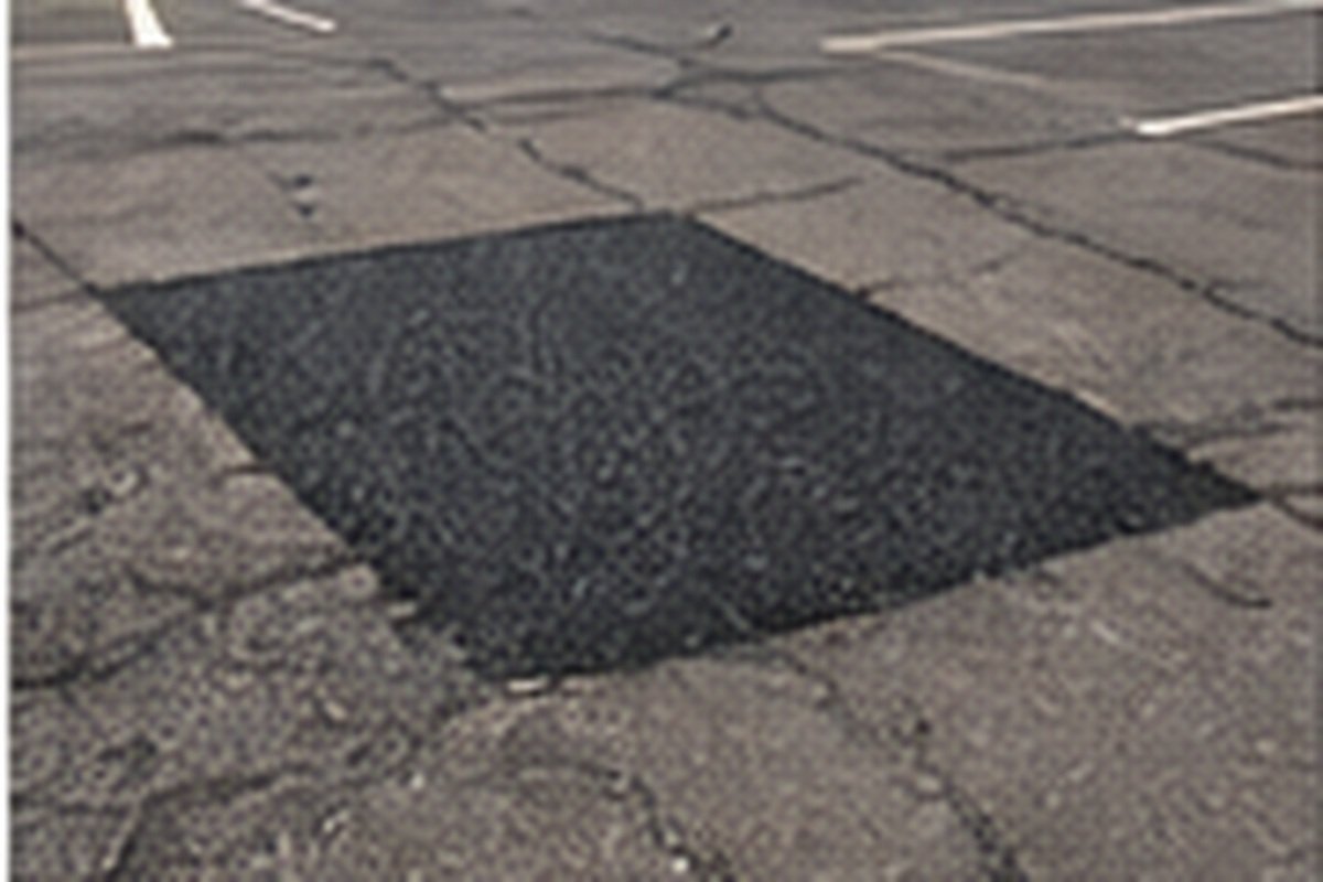 Full-depth asphalt patching crew at work on a Wichita commercial lot